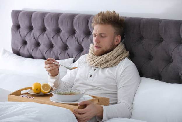 Sick Young Man Eating Soup To Cure Flu in Bed Stock Photo - Image of food,  illness: 161050680